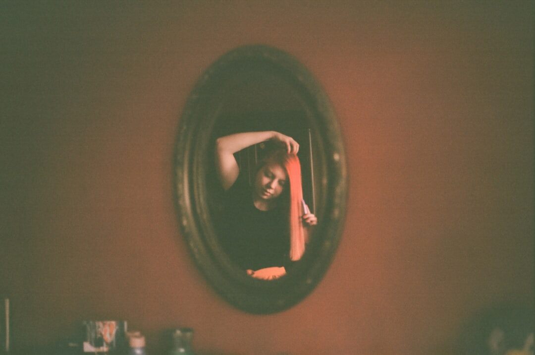person looking at mirror reflection