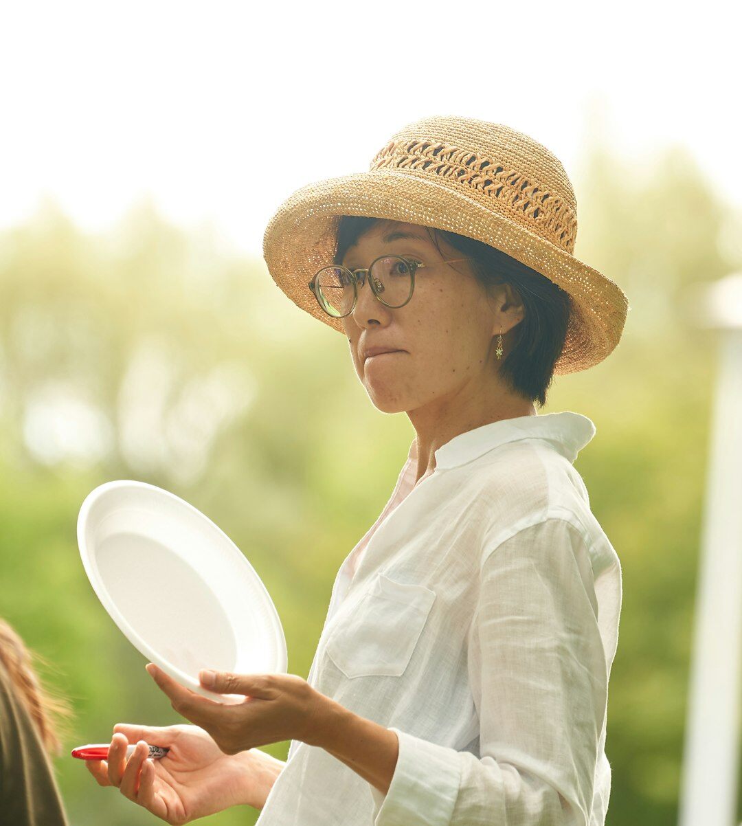 Brazilian woman speaking confidently in front of a small group