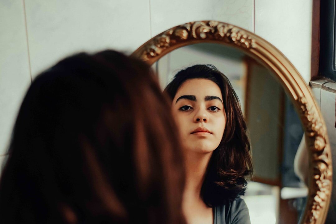 person looking at mirror reflection
